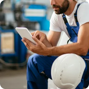 A field service worker efficiently manages detailed timesheets on a tablet, streamlining operations and ensuring accurate time tracking directly from the job site.