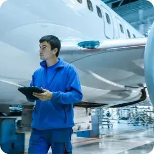 An aircraft maintenance technician performs a digital asset check using a tablet, showcasing how mobile solutions improve the accuracy and efficiency of critical asset inspection processes.