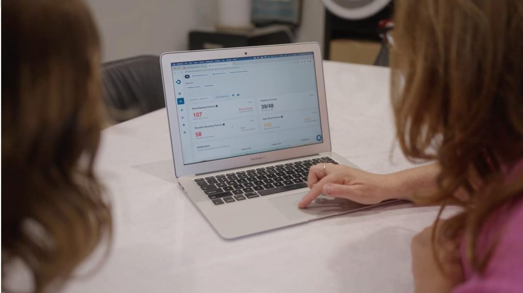 Tutor showing online reading assessment report